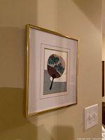 oblique view of framed fan print on wall