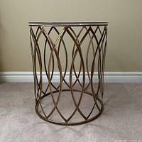 Side view of table showing full metal lattice base and glass top