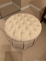 Top view showing button-tufted surface and round shape