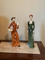 Front view of both Royal Doulton lady figurines