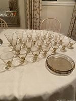 Assorted stemmed glasses and stacked plates on table
