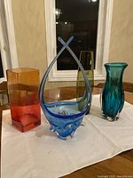 All four colored glass vases on table