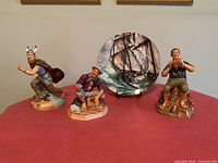 Front view of three figurines and plate