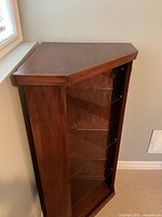 Front view of wood corner cabinet