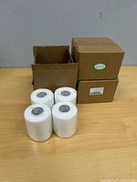 Three Enongarden boxes, one open, with four white rolls displayed