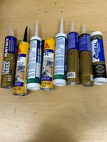 All eight adhesive and sealant tubes lined up