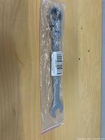 Wrench sealed in plastic sleeve showing full length