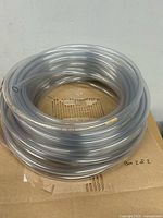 Coiled clear vinyl tubing on cardboard