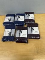Six packaged tights on table