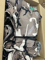 Camouflage garments inside box