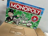Front of sealed Monopoly box on cardboard surface
