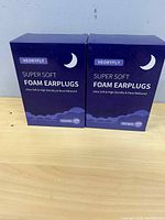 Front view of two sealed VEORYFLY earplug boxes
