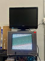 Both televisions stacked, showing overall condition