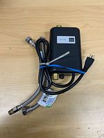 Front view showing housing, display, hoses, plug