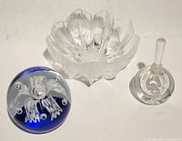 Group shot of blue paperweight, clear bowl and clear scent bottle