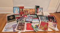 overview of assorted boxed and loose holiday greeting cards spread on floor
