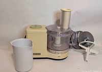 Full view of food processor with jug, discs, plastic dough blade