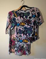 Both tops on hangers showing overall designs