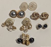 All seven earring pairs laid out