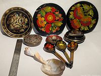 Group shot of all plates, coasters, spoons and boxes with ruler for scale