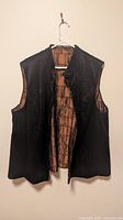 Vest black faux fur side displayed open on hanger