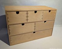 Front view of six-drawer plywood chest closed