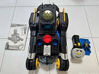 Top view of Batmobile, remote, minifigure, instruction sheet