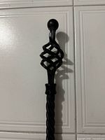 Close-up of decorative cage finial on rod end