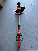 Full view of Black & Decker corded string trimmer showing shaft, handle, guard and head