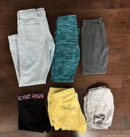 All six garments laid flat showing fronts