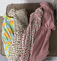 Four dresses laid out showing patterns and colours
