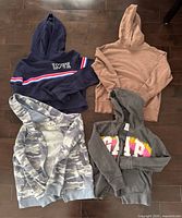Four hoodies laid flat showing colours and designs