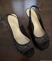 Top view of both shoes showing lace upper, peep toe, slingback straps