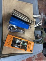 Lot overview: burlap bags, two bottles, Fiskars tool