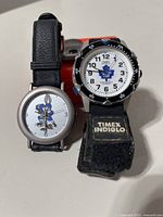 Both watches standing together showing dials and straps