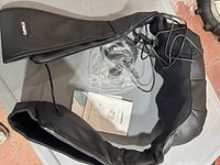 Top view of Naipo neck and shoulder massager with cords and manual