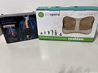 Prospera kneading massage cushion box beside Acevivi therapy wrap box