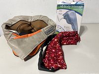 All three items grouped: neck massager, Wahl massager box, red heat pack