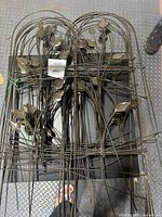 Stack of brown steel garden panels with vine and leaf design