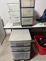 All three organizers grouped: white mesh, black plastic, clear plastic with gray top