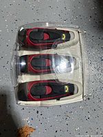 Front view of three identical flashlights in clear clamshell packaging