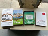 Front view of four paperback books lined up