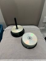 Two spindles of blank CDs on seat