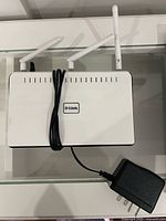 Front/top view of D-Link DIR-655 router with antennas and power adapter