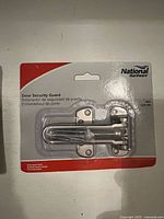 Front of unopened National Hardware door security guard package