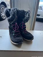 Front view of both boots showing laces, toe condition and overall appearance