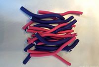 Pile of purple and pink foam bendy hair curlers