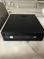 Front view showing optical drive, power button, audio jack and four USB ports