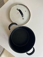 Top view of open stockpot with lid alongside