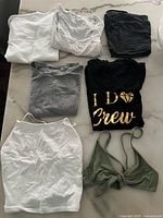 All seven tops laid out on surface